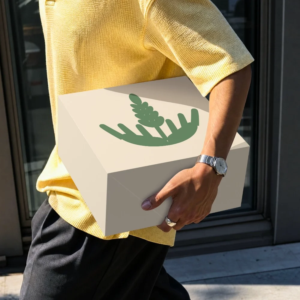 A carried delivery box printed with the EcoBites mark